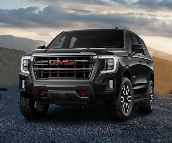 Front view of a black GMC luxury SUV on a city boulevard