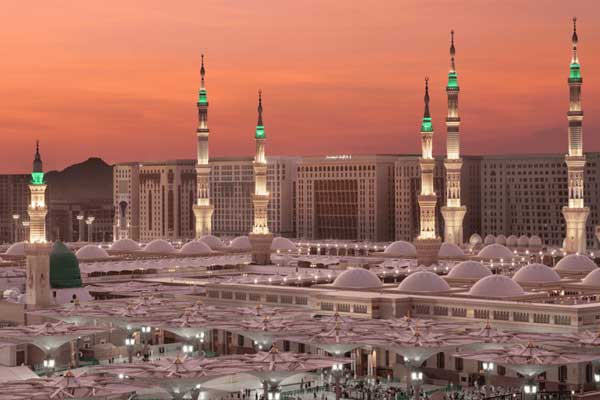 Green-domed Prophet’s Mosque in Madinah at twilight